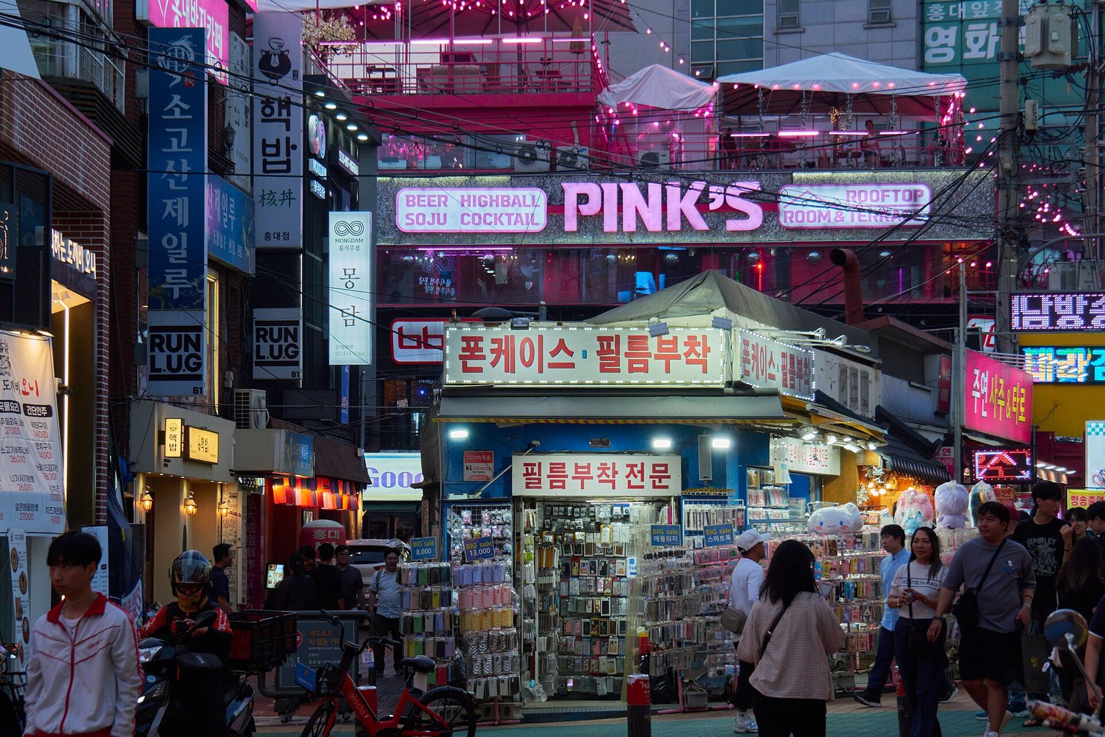 Hongdae street in Seoul with Korean shop signs at dusk